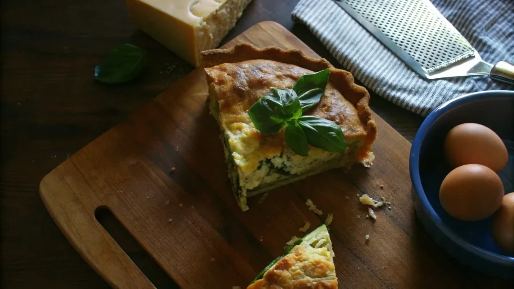 Freshly baked zucchini pie with a golden crust, sliced to reveal zucchini filling.