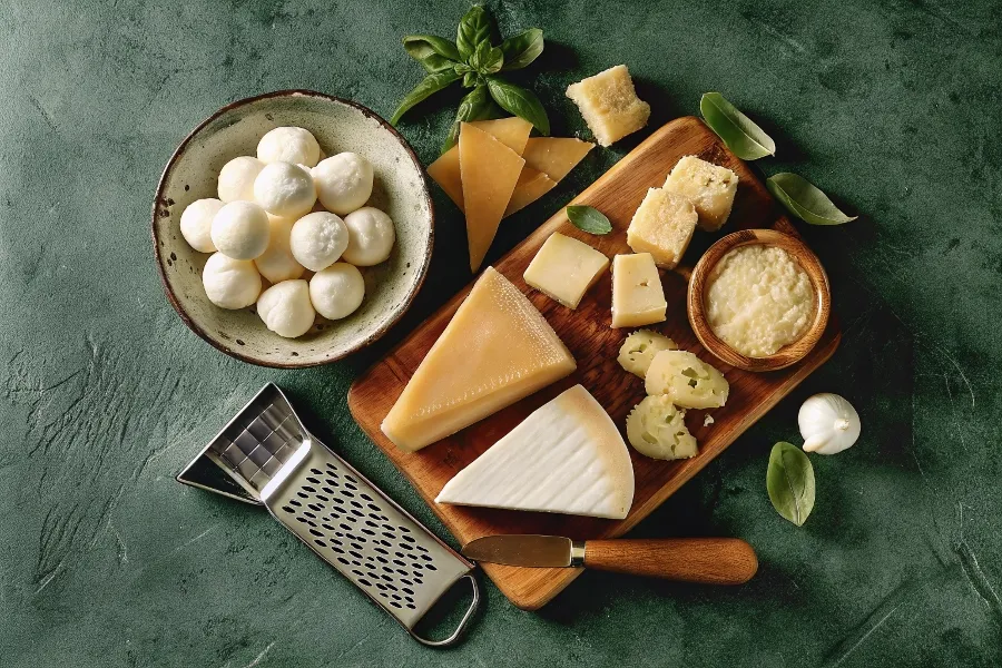 A display of Italian cheeses like mozzarella and Parmigiano-Reggiano, used as ricotta alternatives in lasagna recipes.