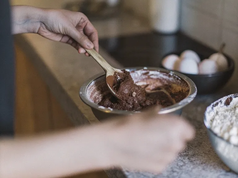 Mixing chocolate cake batter with fresh ingredients for National Chocolate Cake Day.