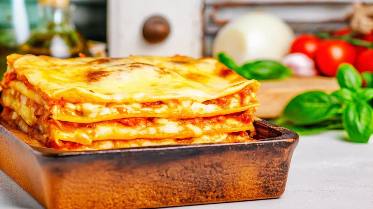 lose-up of traditional Italian lasagna with golden cheese and ricotta layers.